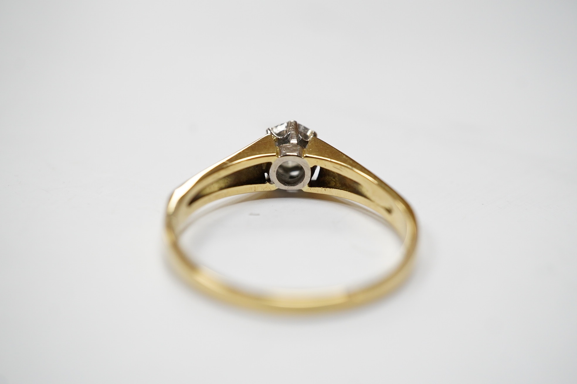 A yellow metal and illusion set solitaire diamond ring, size O/P, gross weight 2.7 grams. Condition - fair